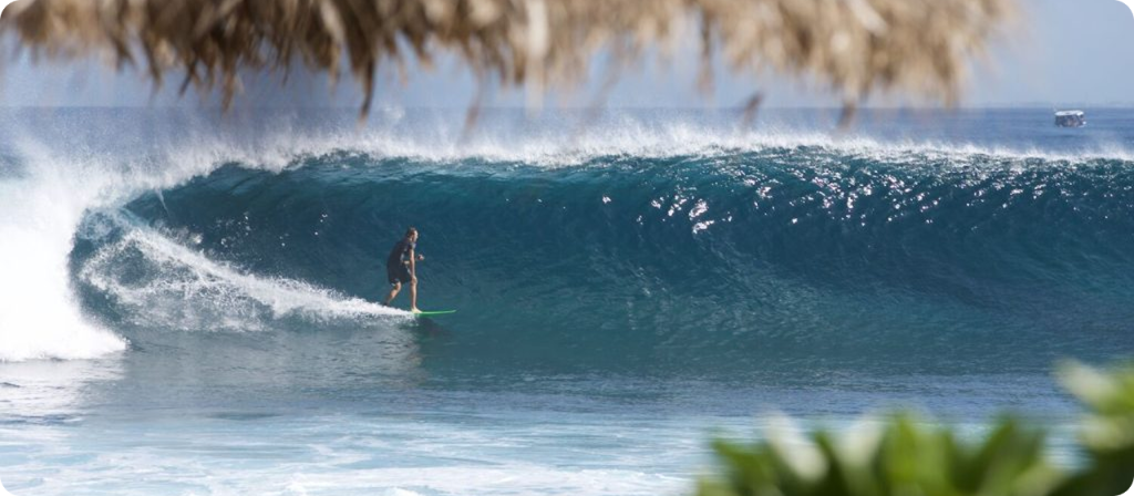 View of surfer riding riding wave from resort